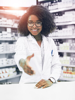Buy stock photo Portrait of a cheerful young female pharmacist reaching out to shake hands while looking at the camera in a pharmacy