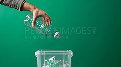 Hand, recycle and volunteer throwing bottle in dustbin for environmental, awareness and sustainability concept. Plastic and green background with copyspace for Earth Day, eco system or ecology
