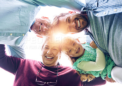 Buy stock photo Low angle shot of a multigenerational family outside