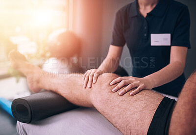 Buy stock photo Cropped shot of an unrecognizable female physiotherapist treating a male patient
