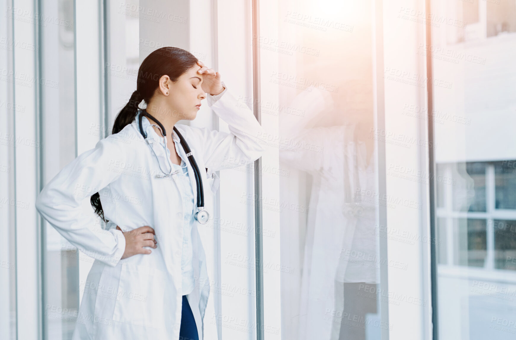 Buy stock photo Woman, doctor and headache in stress, burnout or mistake against glass window in hospital building. Frustrated or sad physician or medical healthcare person in grief, loss or failed surgery at clinic