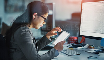 Buy stock photo Shot of a young businesswoman working late in the office