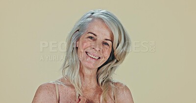 Face, skincare and elderly woman with a smile, wellness and cosmetics on a studio background. Portrait, model and pensioner with texture, volume or senior person with mockup space, wellness or luxury