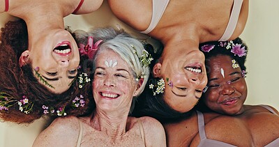 Diversity, face flowers and women relax for self love, natural facial beauty and solidarity. Woman empowerment, creative eco design and floral group, friends or people on floor on studio background