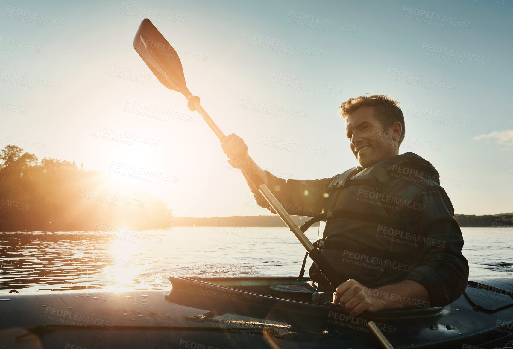 Buy stock photo Happy man, canoeing and ocean with paddle in sunset for travel, hobby or outdoor holiday journey in water, lake or nature. Male person rowing boat with smile or sunshine for adventure in kayak at sea