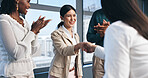 Business woman, handshake and meeting applause for partnership, onboarding and thank you or congratulations. People or employees shaking hands for deal, agreement and team clapping for promotion