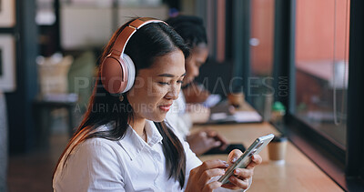 Woman, headphones and cafe with smartphone, streaming music and singing in shop, texting and social media. Happy, young and technology for podcast, listening and networking on subscription app