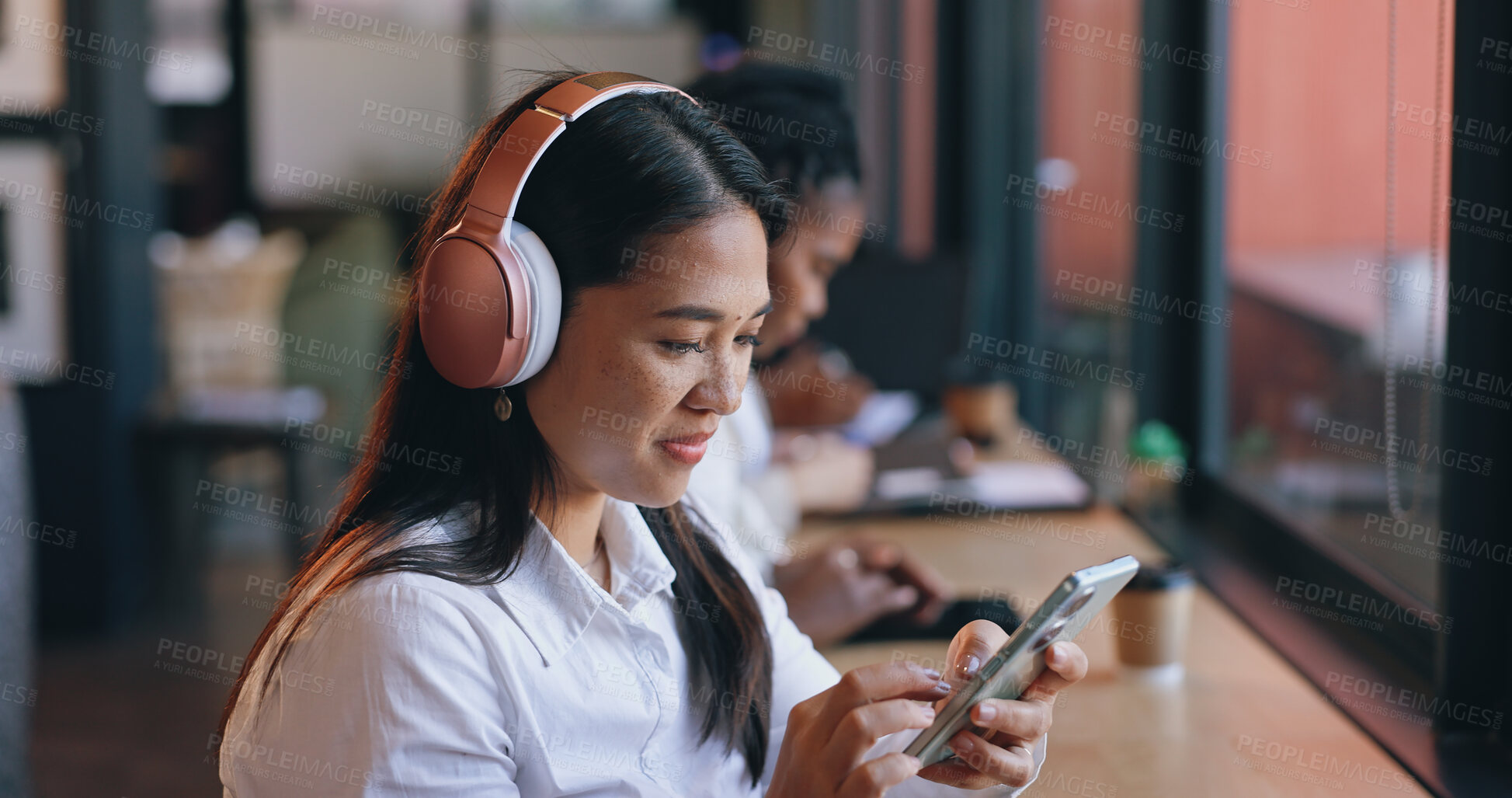 Buy stock photo Woman, headphones and cafe with smartphone, streaming music and singing in shop, texting and social media. Happy, young and technology for podcast, listening and networking on subscription app