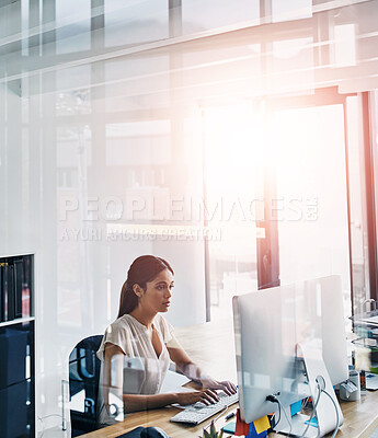 Buy stock photo Cropped shot of an attractive businesswoman working  on her computer at her desk