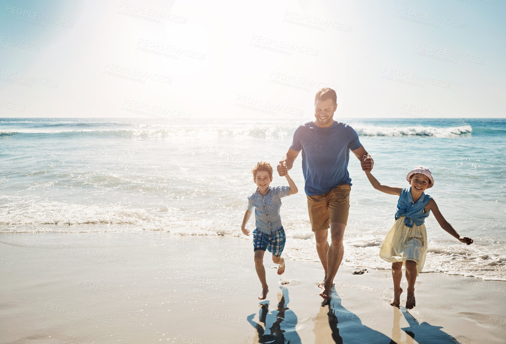 Buy stock photo Happy, holding hands and father with children at beach on holiday, vacation and tropical adventure. Family, travel and kids with dad by ocean for bonding, playing in waves and fun outdoors on weekend