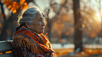 Depressed, elderly mexican and woman sitting in park. Senior, female and mental health concept. Sadness, longing and reflective for mental health and reminiscing with beautiful sunset background