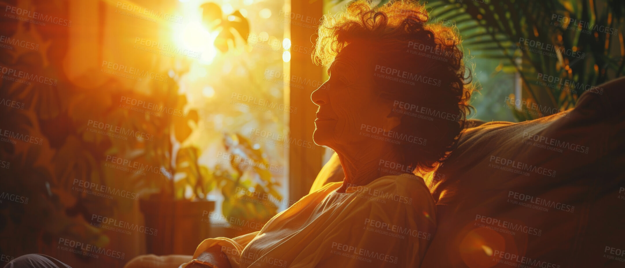 Buy stock photo Depressed, elderly and woman at home. Senior, female and mental health concept in the living room. Sadness, longing and remembering sitting on couch with sunset background and reminiscing about past.