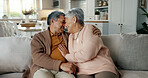 Senior couple, face and hug on sofa, smile and bonding with love, support and relax in retirement in home. Elderly woman, old man and happy with embrace, together and sitting on living room couch