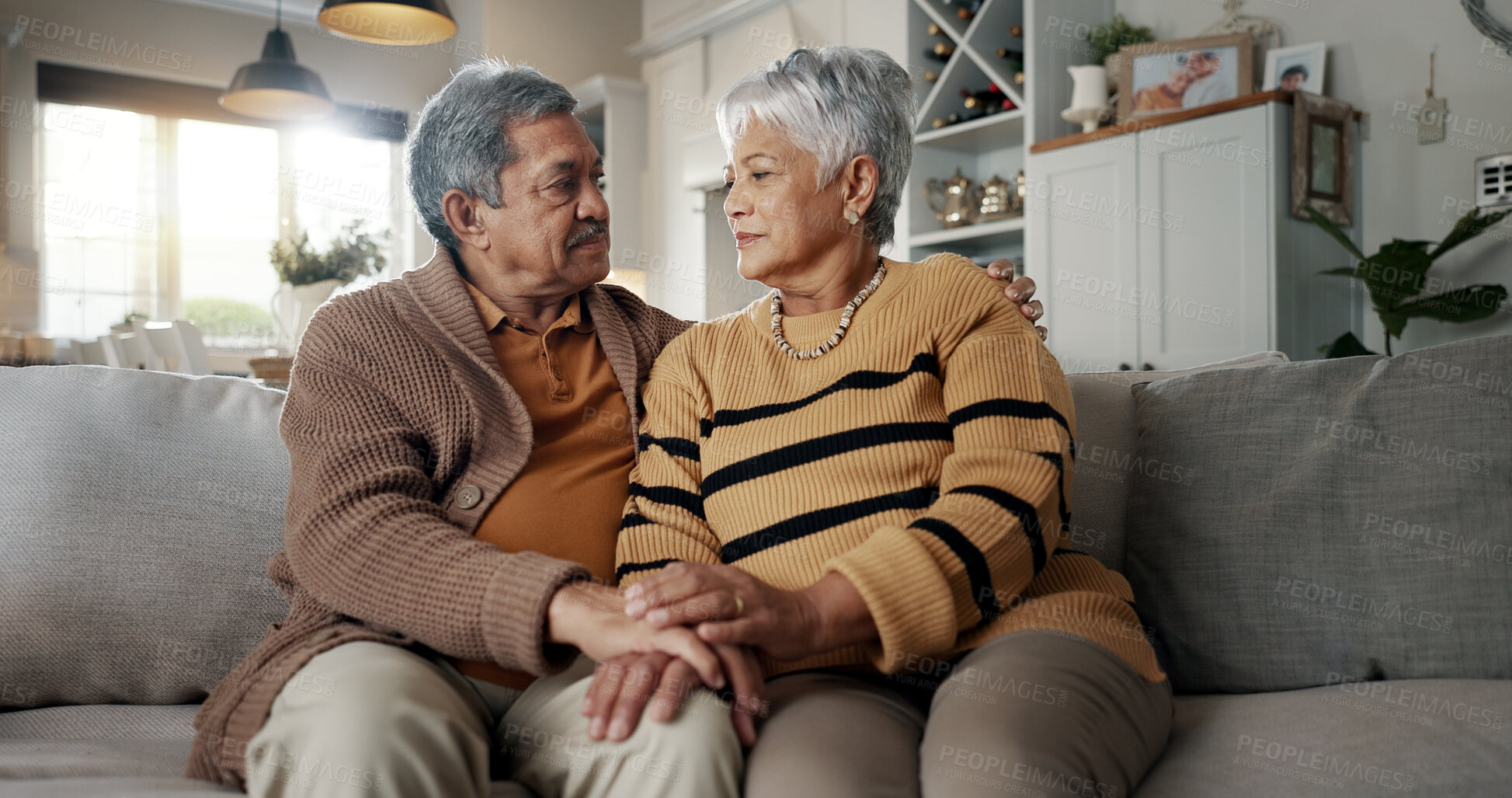 Buy stock photo Senior, couple and hug for empathy on sofa with support, grief and comfort in living room of house. Old people, man and woman with love and embrace for security, compassion and sympathy on couch