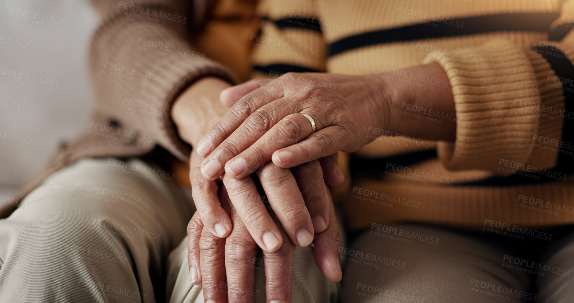 Buy stock photo Senior, couple and hands for empathy on sofa with support, grief and comfort in living room of house. Old people, man and woman with love and embrace for security, compassion and sympathy on couch