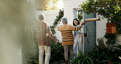 Happy family, open door and hug with flowers outdoor of home in backyard with daughter and parents with love. Reunion, welcome and woman with mom and dad, travel and surprise for holiday with embrace