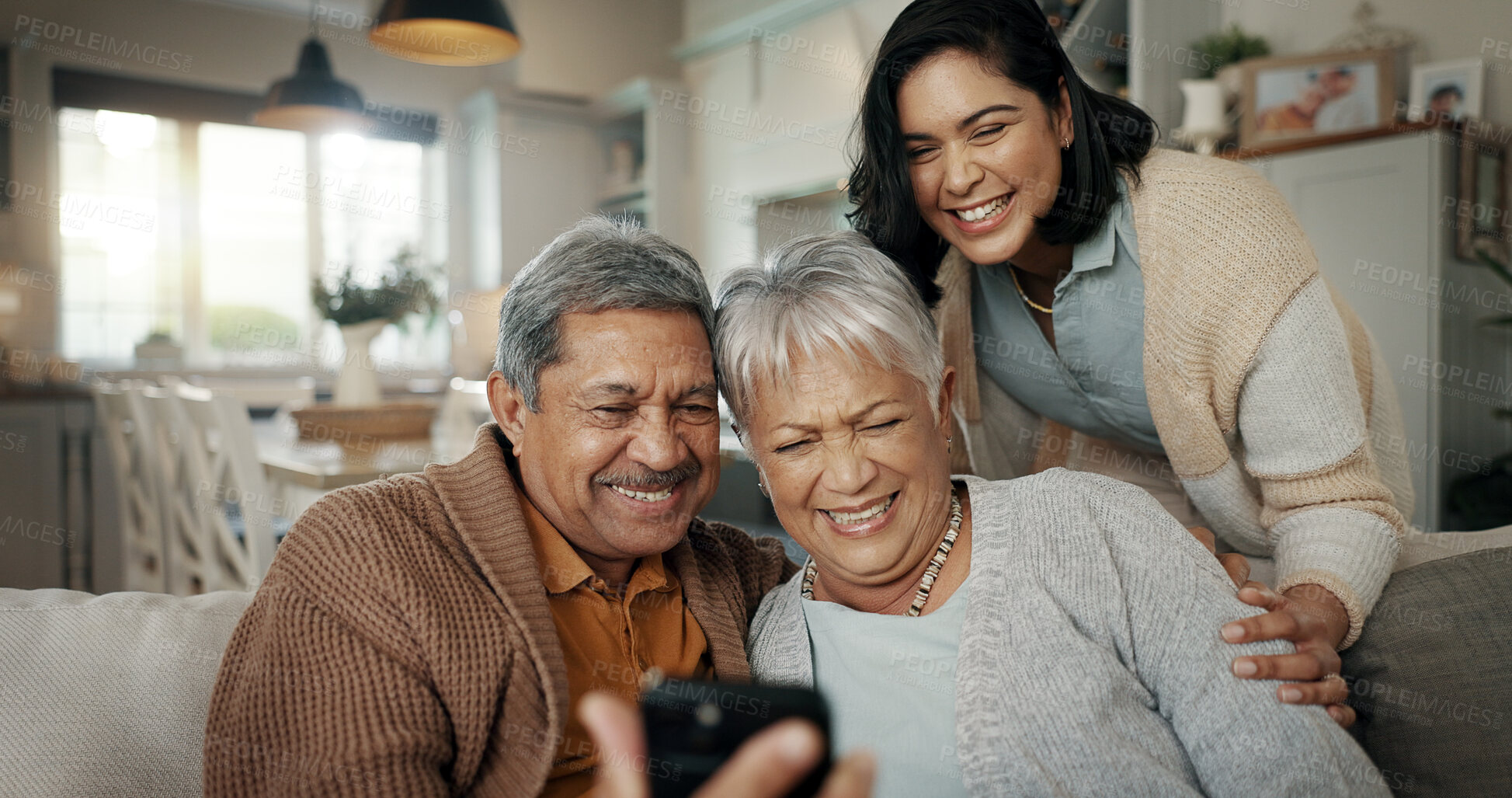 Buy stock photo Video call, living room and woman with elderly parents on a sofa relaxing and talking on a phone. Smile, bonding and female person with senior people on virtual conversation with cellphone at home.