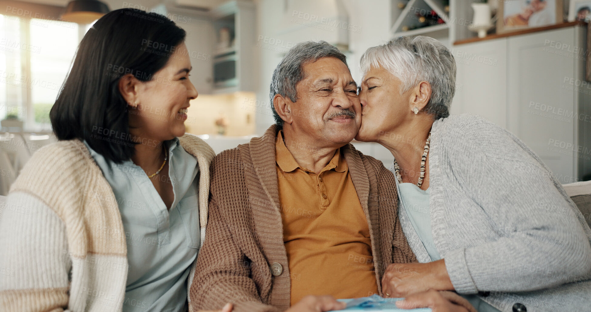 Buy stock photo Birthday, gift and senior parents on sofa for celebration, festive event and bonding together at home. Happy family, party and elderly mother and father with daughter for present, surprise and love