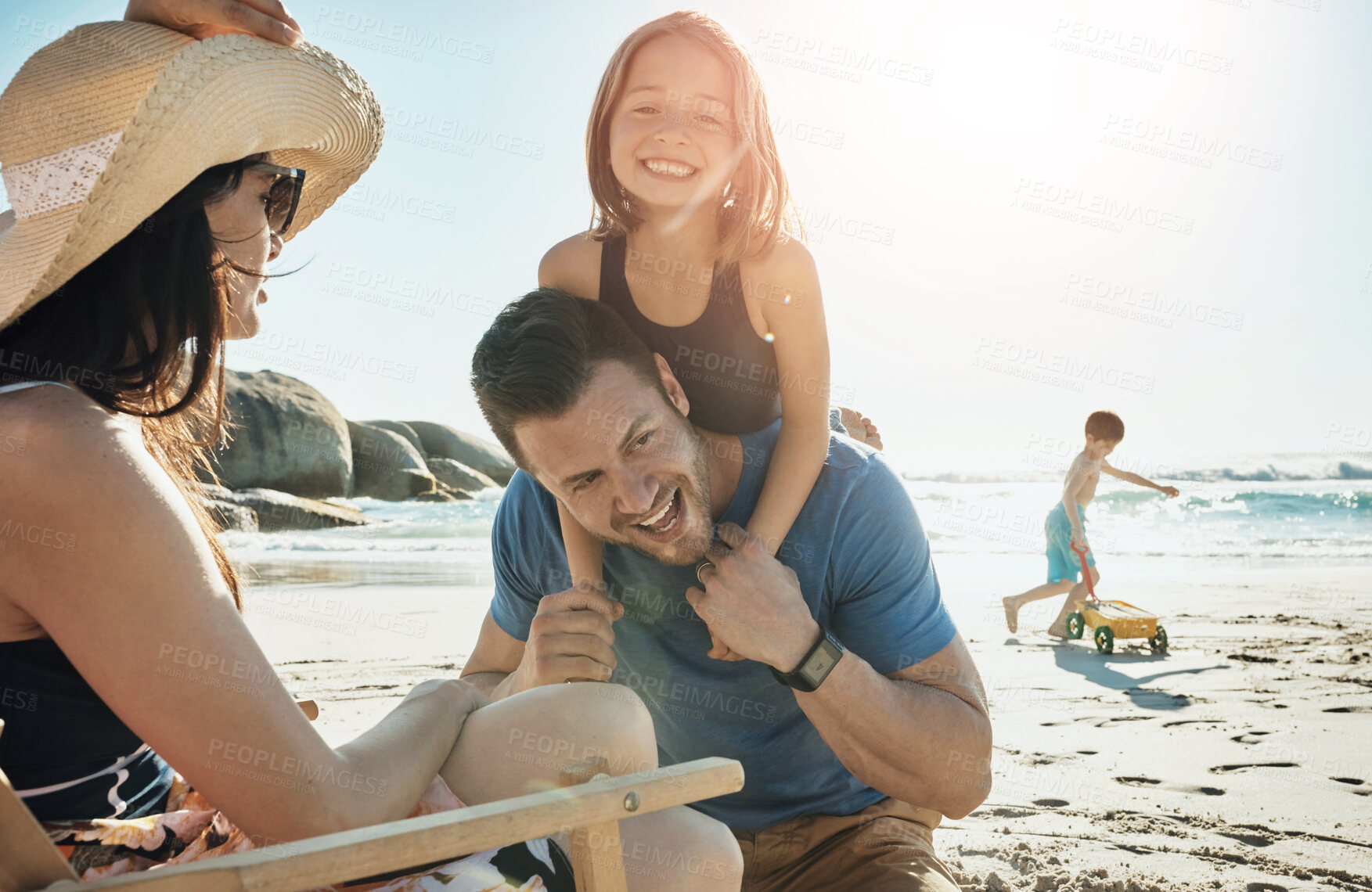 Buy stock photo Parents, children and playful at beach, vacation and piggy back in summer, portrait and happy for bonding. Father, mother and kids with family, holiday and care with love in sunshine by sea in Miami