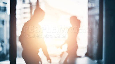 Buy stock photo Defocused shot of two businesspeople working in an office