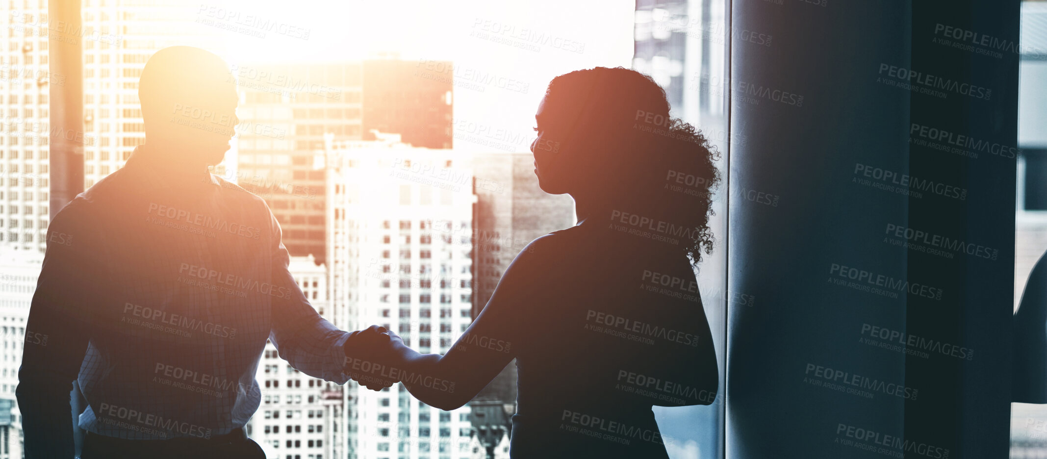 Buy stock photo Handshake, meeting and silhouette of business people by window for teamwork, collaboration and partnership. Corporate, lens flare and man and woman shaking hands for agreement, b2b deal and thank you