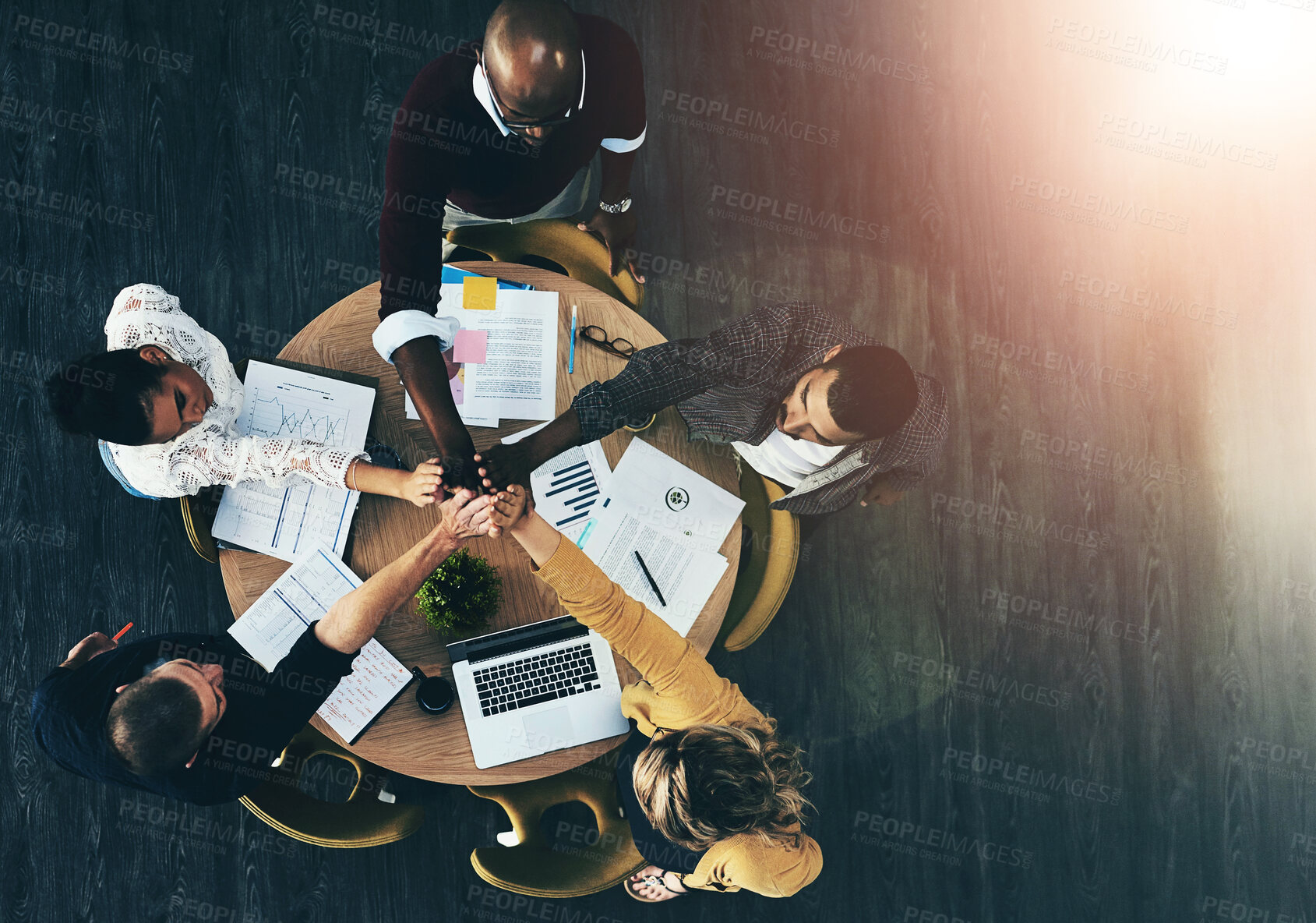 Buy stock photo Above, business people and high five in circle, meeting or support for motivation, teamwork and diversity. Men, women and hands together in scrum by documents, technology or graphs at creative agency