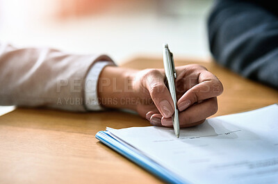 Buy stock photo Cropped shot of a businessman and businesswoman completing paperwork together at a desk