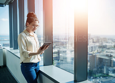 Buy stock photo Businesswoman, office and tablet at window for reading, information and research in company. Woman, journalist and technology in city for news, updates and communication in corporate workplace