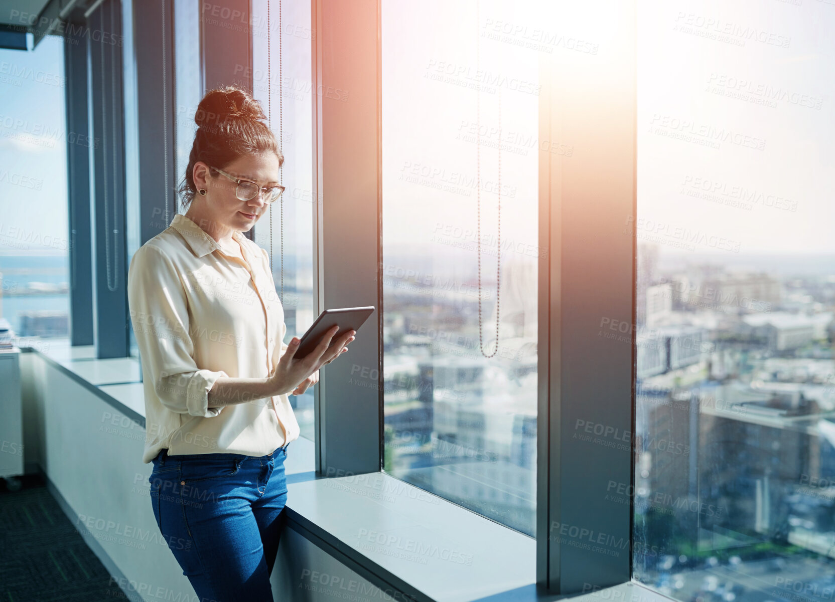 Buy stock photo Businesswoman, office and tablet at window for reading, information and research in company. Woman, journalist and technology in city for news, updates and communication in corporate workplace