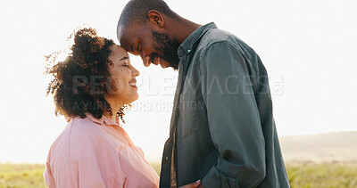 Couple, love and forehead touch in nature for bonding together, sunlight and happy in marriage. Interracial people, holiday and commitment in relationship, partnership and trust or care in outdoors