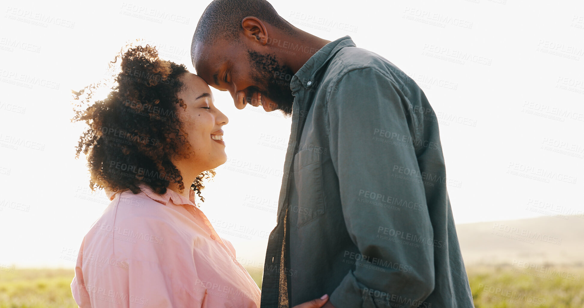 Buy stock photo Couple, love and forehead touch in nature for bonding together, sunlight and happy in marriage. Interracial people, holiday and commitment in relationship, partnership and trust or care in outdoors