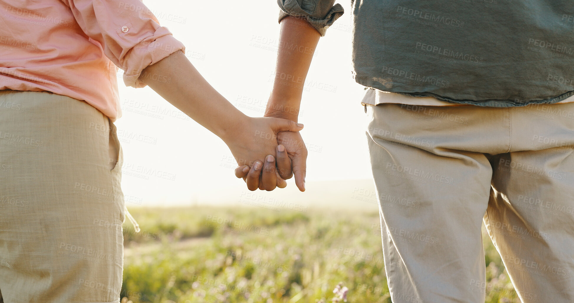 Buy stock photo Outdoor, closeup and couple with love, holding hands and romance with nature, lens flare and romance. Unity, man and woman with sunshine, union and marriage with trust, relationship and summer break