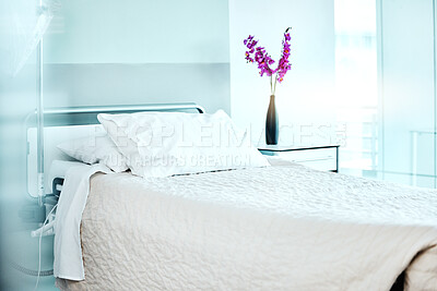 Flowers, empty and bed at medical hospital for sickness, injury or surgery recovery or resting. Pillow, blanket and comfortable modern interior of ward with floral plant in healthcare clinic.