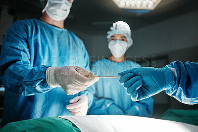 Surgeon, hands and scalpel in operating room at hospital in scrubs, ppe or emergency healthcare procedure. Doctors, group and together in icu, medical surgery or tools for help for wellness at clinic