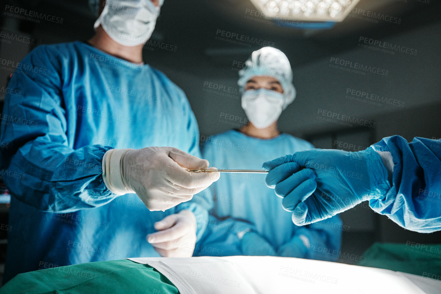 Buy stock photo Surgeon, hands and scalpel in operating room at hospital in scrubs, ppe or emergency healthcare procedure. Doctors, group and together in icu, medical surgery or tools for help for wellness at clinic