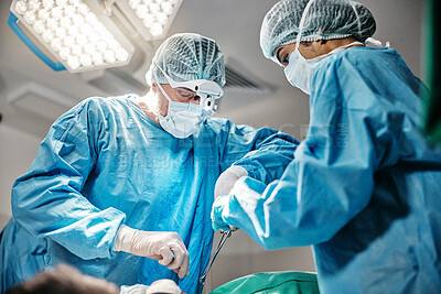Theatre, tools or surgeons with teamwork for emergency, accident or healthcare help in hospital clinic. Surgery operation, low angle or doctors in surgical collaboration in operating room to support