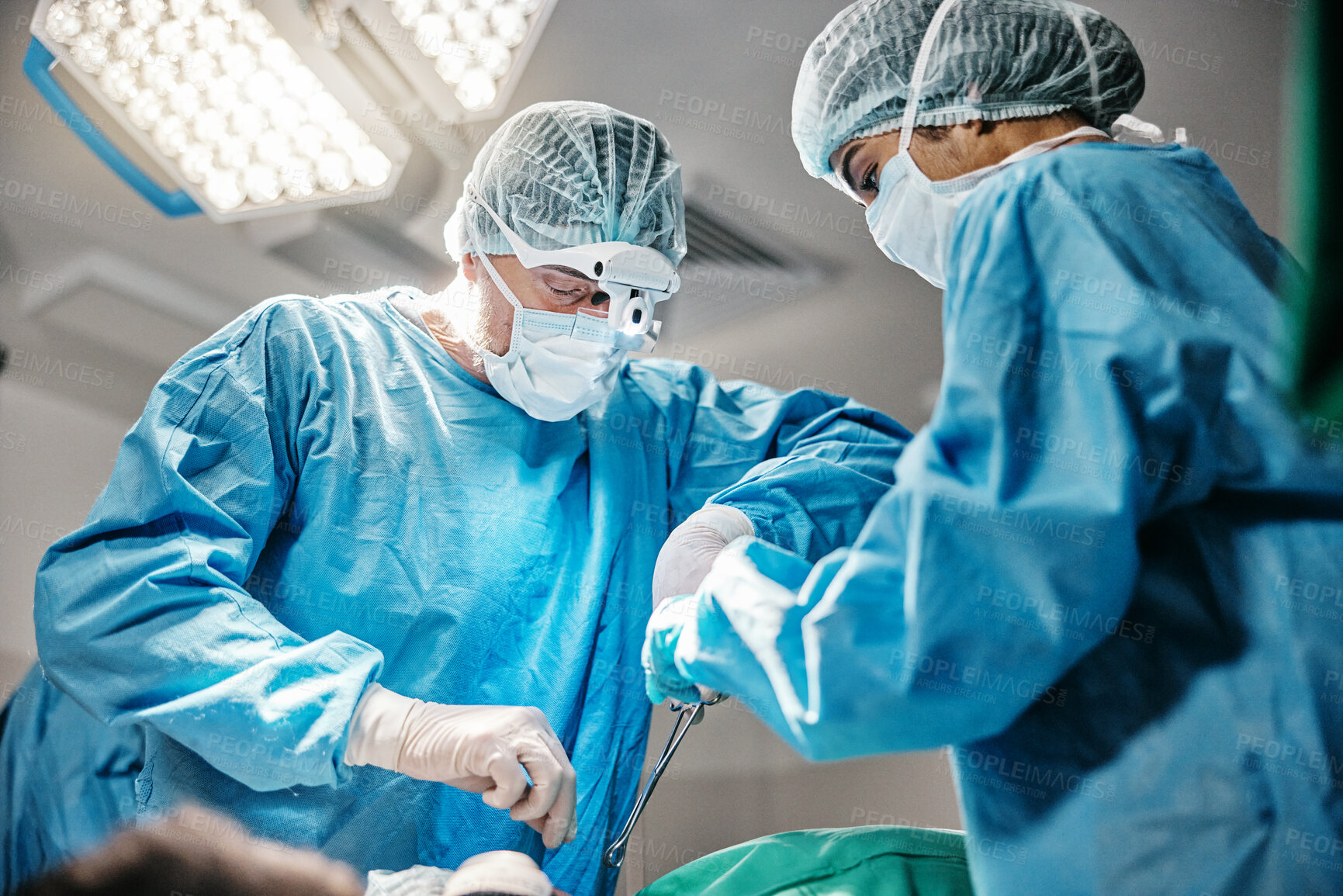 Buy stock photo Theatre, tools or surgeons with teamwork for emergency, accident or healthcare help in hospital clinic. Surgery operation, low angle or doctors in surgical collaboration in operating room to support