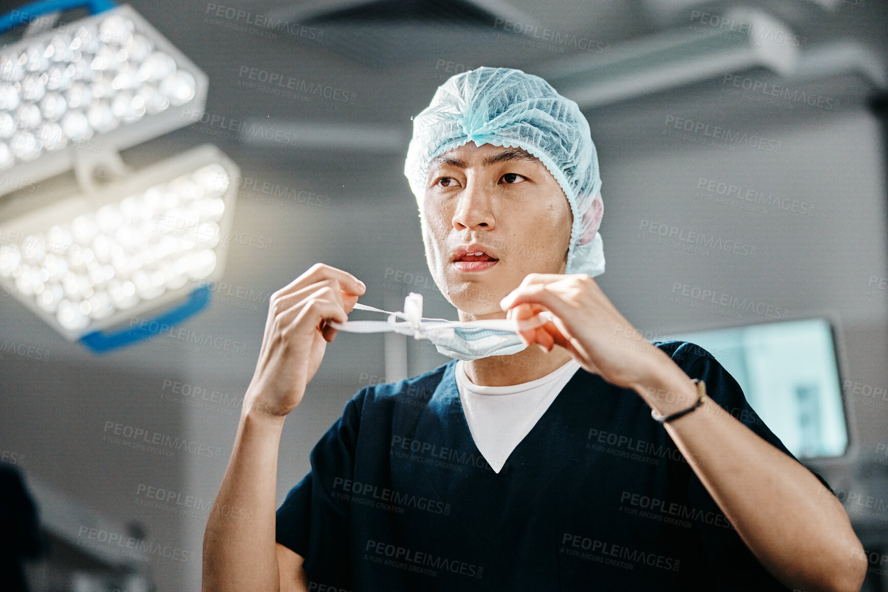 Buy stock photo Medical, uniform and doctor in theatre for surgery, safety and preparation for operation in hospital. Asian man, surgeon and clothes with thinking for cardiology procedure, protection and healthcare
