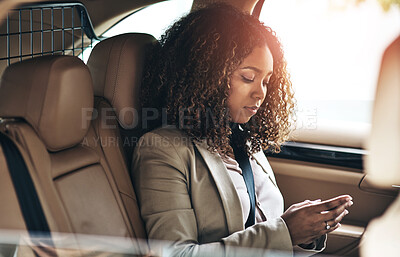 Buy stock photo Shot of an attractive businesswoman using a cellphone on her morning commute