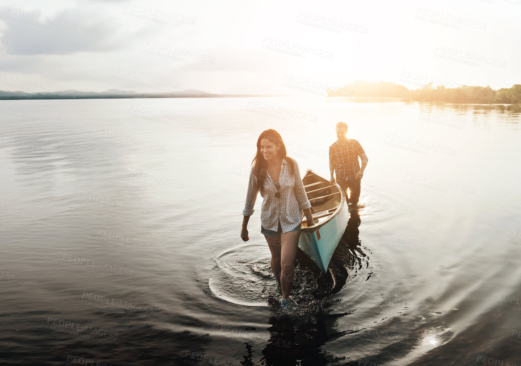 Buy stock photo Walking, water and couple with boat by lake for adventure, summer and sunset in nature. Man, woman and sunshine or happiness for travel, freedom and support or canoe for wellness by river or creek 