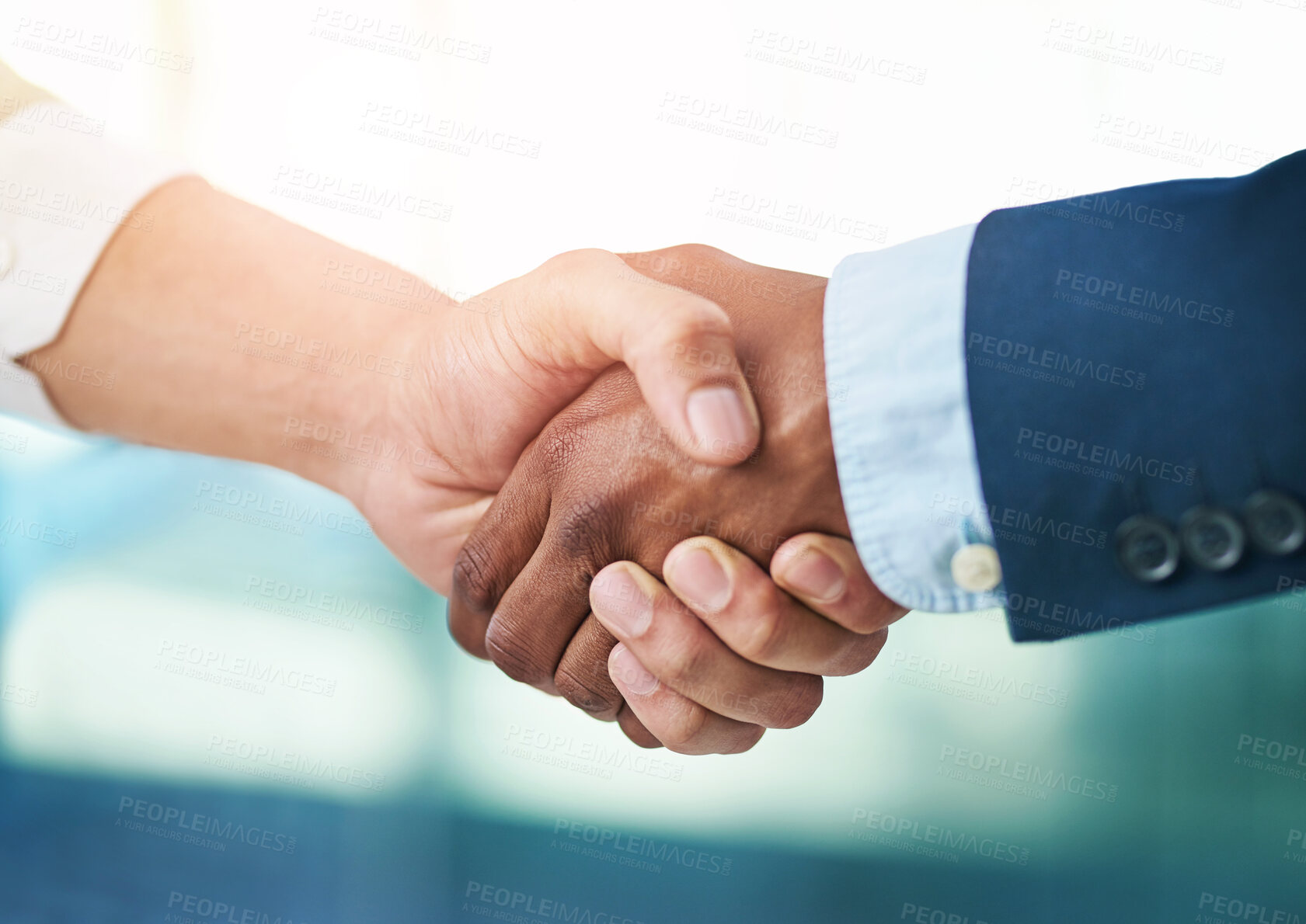 Buy stock photo Cropped shot of two businessmen shaking hands in a modern office