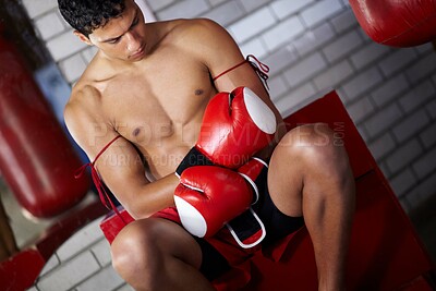 Buy stock photo Fitness, gym and a man with gloves for boxing, cardio and getting ready for a match. Strong, exercise and a boxer, fighter or athlete with equipment to start a martial arts competition at a club