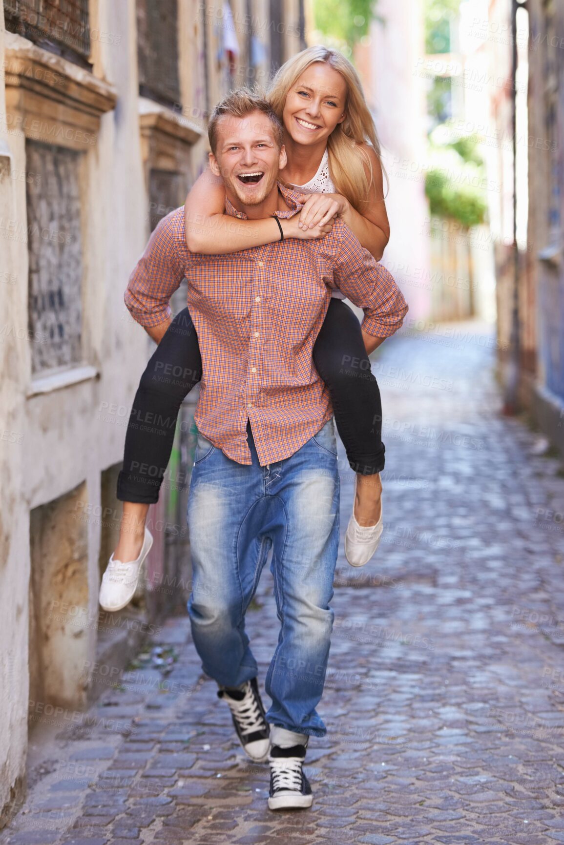 Buy stock photo Couple, happy or piggyback on street in city, fun support or romance in committed relationship. Excited man, woman and smile for adventure in amsterdam, travel and care for love together on honeymoon