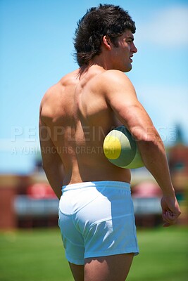 Buy stock photo Back, shirtless and male rugby player with a ball thinking on a field for sports plan and game. Competition, workout and training with a topless athlete with vision and strategy outdoors 