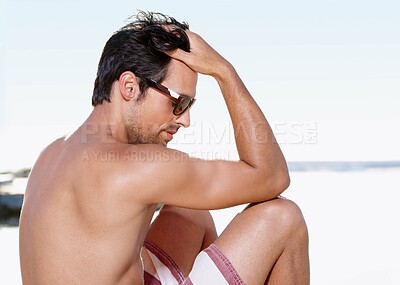 Buy stock photo Swimsuit, sunglasses and beach with man, relax and summer with tropical island getaway and vacation. Person, holiday and guy with eyewear and travel with ocean, peaceful and tattoo with sunshine