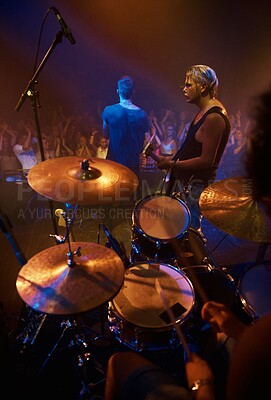 Buy stock photo Drummer, musician and band at stage for concert, performance and crowd at night. Music festival, talent and people playing for audience in theater or club with instrument, light and creative energy
