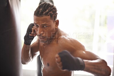 Buy stock photo Boxing, portrait and black man with punch in gym for fitness challenge, fight and competition training. Power, muscle and serious face of champion boxer at workout with confidence in sports club.