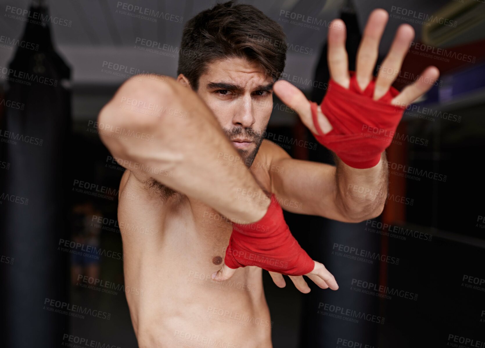 Buy stock photo Man, portrait and ready for fight in gym, fitness and topless for exercise and workout. Male person, bodybuilder and punching bag for challenge or practice, training and serious face for competition