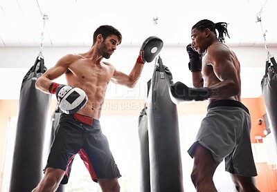 Buy stock photo Men, boxing and training with gloves or pad or fighting performance or endurance challenge, progress or workout. Male people, personal trainer and battle with confidence or sport, exercise or fitness