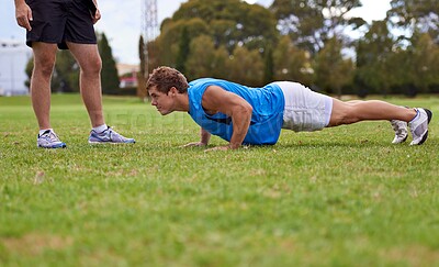 Buy stock photo Men, push up and personal trainer on field for exercise with counting for stats, progress or development. Person, coach or mentor with inspection for balance, training or workout for health on grass